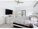 Bright main bedroom with a ceiling fan, light colored walls, and a modern dresser at 9055 Treasure Trove Ln # 207, Kissimmee, FL 34747
