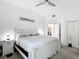 Bright main bedroom with 'Farmhouse' wall decor, carpet floors, and a view into the large walk-in closet at 9055 Treasure Trove Ln # 207, Kissimmee, FL 34747