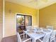 Enjoy this screened patio featuring dining seating and sliding door access to the home at 9055 Treasure Trove Ln # 207, Kissimmee, FL 34747