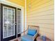 Enjoy the outdoors with this patio featuring a screened door, a wicker chair and pillow at 9055 Treasure Trove Ln # 207, Kissimmee, FL 34747