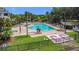 Resort-style pool with sun loungers, tables, and lush landscaping offering a relaxing vacation experience at 9055 Treasure Trove Ln # 207, Kissimmee, FL 34747
