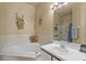 Bathroom featuring a garden tub and a vanity with a large mirror at 906 Berwick Dr, Davenport, FL 33897