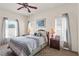 Bedroom with ceiling fan, windows with natural light, and nightstands with lamps at 906 Berwick Dr, Davenport, FL 33897