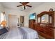 Bedroom features a large dresser, ceiling fan, and en suite bathroom at 906 Berwick Dr, Davenport, FL 33897