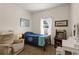 Cozy bedroom with a single bed, recliner, game console, and natural light at 906 Berwick Dr, Davenport, FL 33897