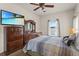 Primary bedroom with a ceiling fan, dresser, and a window view of the pool at 906 Berwick Dr, Davenport, FL 33897