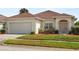 Charming single-story home with a well-maintained lawn and two-car garage at 906 Berwick Dr, Davenport, FL 33897