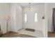 Bright foyer with tile floors, a chandelier, and transom window at 906 Berwick Dr, Davenport, FL 33897