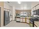 Spacious kitchen with stainless steel appliances, white cabinets, and view to an adjacent living space at 906 Berwick Dr, Davenport, FL 33897