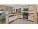 Spacious kitchen with white cabinets, stainless steel appliances, and tile flooring leading to the living room at 906 Berwick Dr, Davenport, FL 33897