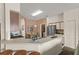 Bright kitchen features white cabinets, breakfast bar, stainless appliances, and doorway to a laundry room at 906 Berwick Dr, Davenport, FL 33897