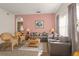 Comfortable living room with pink accent wall, carpeting, and arched doorway at 906 Berwick Dr, Davenport, FL 33897
