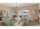 Bright living room featuring two sofas, sliding glass doors to the patio, and coastal accents at 906 Berwick Dr, Davenport, FL 33897