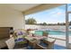 Outdoor patio with table, chairs, and pool view beyond screen enclosure at 906 Berwick Dr, Davenport, FL 33897