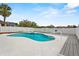 Backyard pool with fence, decking, palm tree, and seating at 906 Berwick Dr, Davenport, FL 33897
