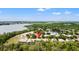 Expansive aerial view of the property showcases its location near a serene lake and lush greenery at 9128 Stromboli Ct, Kissimmee, FL 34747