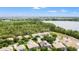 Panoramic aerial view showcasing the property's proximity to a lake and beautiful landscaping at 9128 Stromboli Ct, Kissimmee, FL 34747