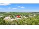 Aerial image highlighting a home nestled among mature trees with a pond nearby at 9128 Stromboli Ct, Kissimmee, FL 34747