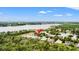 Scenic aerial view of the property situated near a tranquil lake and abundant trees at 9128 Stromboli Ct, Kissimmee, FL 34747