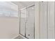 Bathroom showcasing a white tile shower and sliding glass doors at 9128 Stromboli Ct, Kissimmee, FL 34747