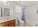 Well-lit bathroom with a classic vanity, toilet, and tub with shower at 9128 Stromboli Ct, Kissimmee, FL 34747