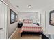 This bedroom features a bed, two end tables, and natural light at 9128 Stromboli Ct, Kissimmee, FL 34747