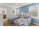 A comfortable bedroom featuring twin beds, with natural light from a window at 9128 Stromboli Ct, Kissimmee, FL 34747