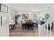 Dining area with natural light, wood floors, and modern decor creating an inviting space at 9128 Stromboli Ct, Kissimmee, FL 34747