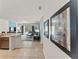 Hallway leading to the living room, showcasing tile flooring and art at 9128 Stromboli Ct, Kissimmee, FL 34747