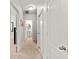 Bright hallway with neutral carpet and white doors leading to various rooms at 9128 Stromboli Ct, Kissimmee, FL 34747