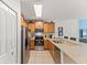 Kitchen featuring stainless steel appliances, wood cabinets, and breakfast bar at 9128 Stromboli Ct, Kissimmee, FL 34747