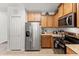 Kitchen featuring stainless steel appliances, granite counters, and wood cabinets at 9128 Stromboli Ct, Kissimmee, FL 34747