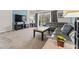 Comfortable living room with large gray sofa, TV, and screened patio access at 9128 Stromboli Ct, Kissimmee, FL 34747