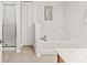 Bright main bathroom with a soaking tub and glass-enclosed shower at 9128 Stromboli Ct, Kissimmee, FL 34747