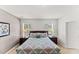 Main bedroom featuring two windows and a comfortable king size bed at 9128 Stromboli Ct, Kissimmee, FL 34747