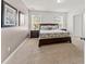 Main bedroom featuring two windows and a comfortable king size bed at 9128 Stromboli Ct, Kissimmee, FL 34747