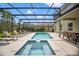Relaxing pool area with lounge chairs under a screened enclosure, featuring a spa at 9128 Stromboli Ct, Kissimmee, FL 34747