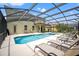 Pool and patio area with lounge chairs and outdoor seating under a screened enclosure at 9128 Stromboli Ct, Kissimmee, FL 34747