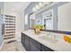 Spacious bathroom with dual sinks, blue accent wall, and shower with striped curtain at 10836 Royal Cypress Way, Orlando, FL 32836