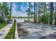 Community boat ramp with a concrete platform, wooden dock, and lake access at 10836 Royal Cypress Way, Orlando, FL 32836