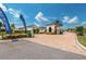 Community entrance featuring a guardhouse, lush landscaping, and signage for Toll Brothers at 10836 Royal Cypress Way, Orlando, FL 32836