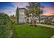 Inviting two-story home with manicured lawn, lush landscaping, and a brick driveway leading to the attached garage at 10836 Royal Cypress Way, Orlando, FL 32836
