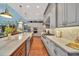 Open kitchen featuring a large island with seating, stainless steel appliances, and stylish pendant lights at 10836 Royal Cypress Way, Orlando, FL 32836