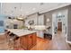 Gourmet kitchen featuring an island with marble countertop, stainless steel appliances, and stylish pendant lighting at 10836 Royal Cypress Way, Orlando, FL 32836