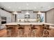 Spacious kitchen with large center island, countertop seating, modern appliances, and hardwood floors at 10836 Royal Cypress Way, Orlando, FL 32836
