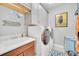 Functional laundry room with gray cabinets, washer, dryer, and laundry sink at 10836 Royal Cypress Way, Orlando, FL 32836