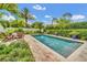 Picturesque backyard features a sparkling pool and lush landscaping at 10836 Royal Cypress Way, Orlando, FL 32836