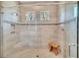 Modern shower stall features tiled walls, glass door, and bench seating at 10836 Royal Cypress Way, Orlando, FL 32836