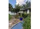 Landscaped front yard with palm trees and a blue walkway at 11922 Ottawa Ave, Orlando, FL 32837