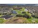 Scenic aerial view of a golf course community featuring lush green fairways, water hazards, and residential homes at 13809 Abberwick Dr, Orlando, FL 32832